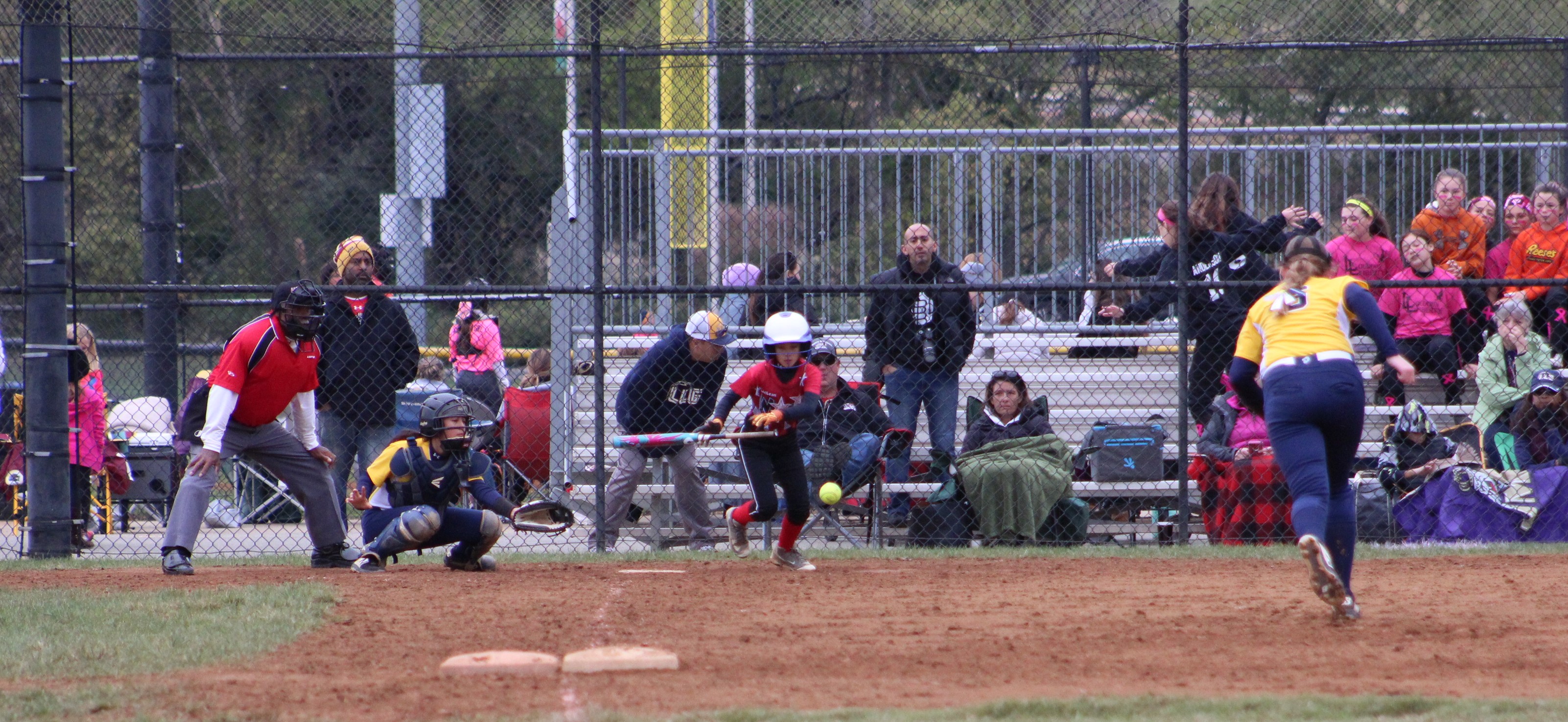 Lauren Kim lays down a bunt to bring in the winning run.